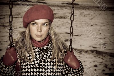 young girl alone on swing