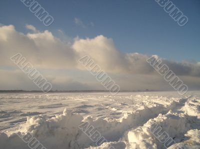 the skidmarks of a car in the snow