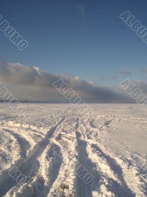 the skidmarks of a car in the snow
