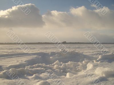 the skidmarks of a car in the snow
