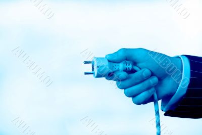 hand with an electric plug