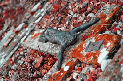 Figure of Jesus on a stone cross on a ground