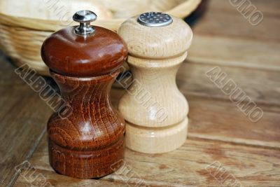 Wooden pepper and salt mill on a table