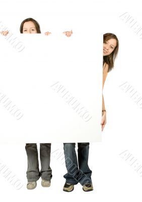 twin sisters holding a white banner