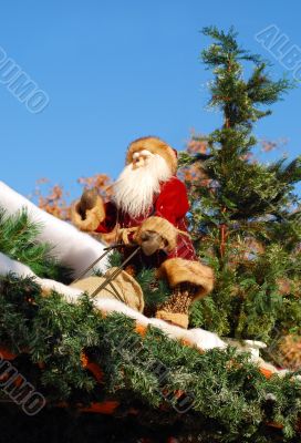 Santa Claus sits on a roof