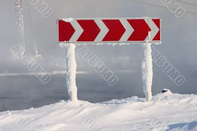 snowed road sign
