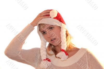 Young womanon cap of Santa thinking about New Year