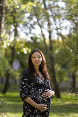 Pregnant woman in park #1