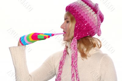 Blond girl in a pink cap remove glove