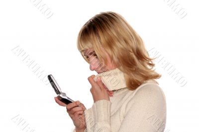 Young blond woman sms by mobile phone.