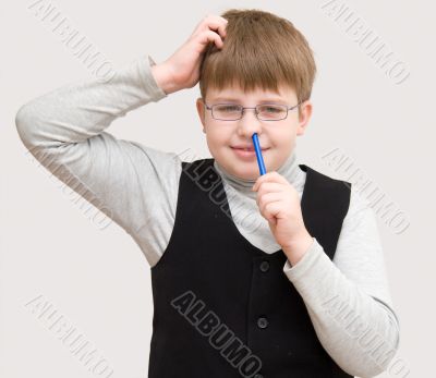 schoolboy picks one`s nose