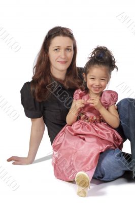mother and daughter sit together and smile