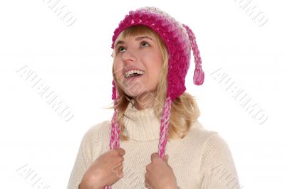 Smiling blond girl in cap is looking up