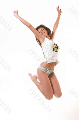 The happy girl jumps in underwear