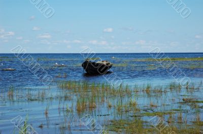 An old fishing boat near the lake bank