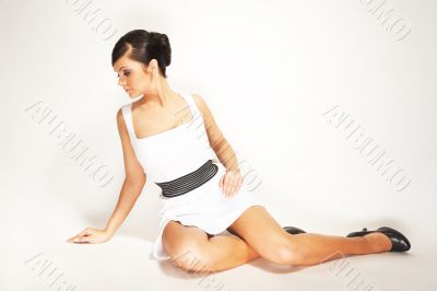 brunette on the light background in white dress