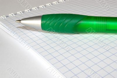 notebook and a green pen