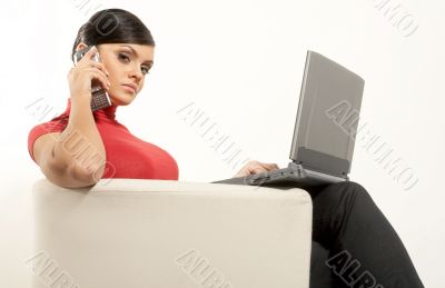 Atractive brunet businesswoman with Laptop and phone