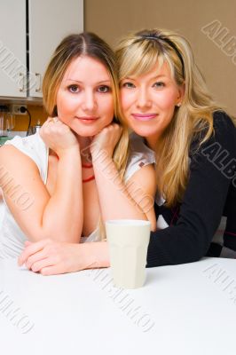 Two smiling girls in the kitchen