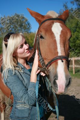 Blond female with brown horse close-up portrait