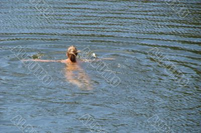 single female swimming in wide water surface