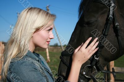 Blond female with brown horse close-up portrait