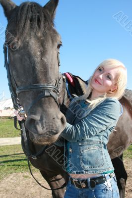Blond female with brown horse close-up