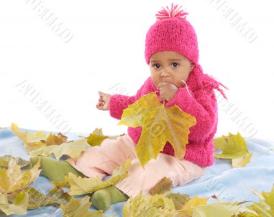 Baby playing with leaves