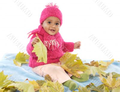 Baby playing with leaves
