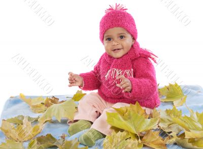 Baby playing with leaves