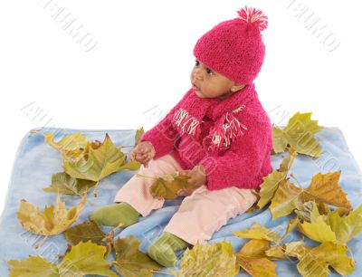 Baby playing with leaves