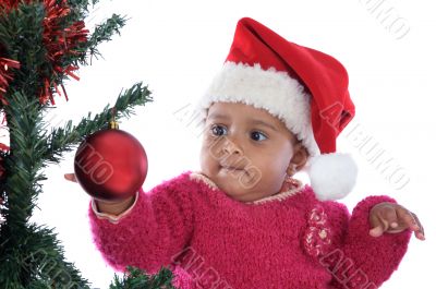 baby girl playing with christmas tree
