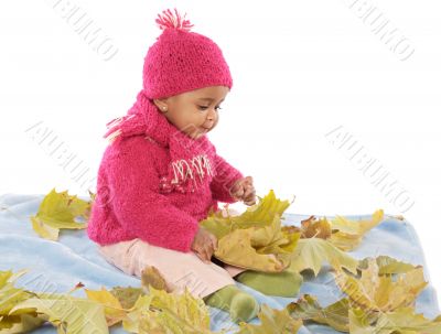 Baby playing with leaves