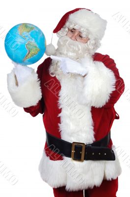 Santa Claus pointing at a globe