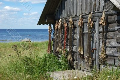 Fishing net on the shed wall near lake