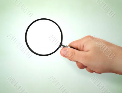 male hand holding magnifying glass