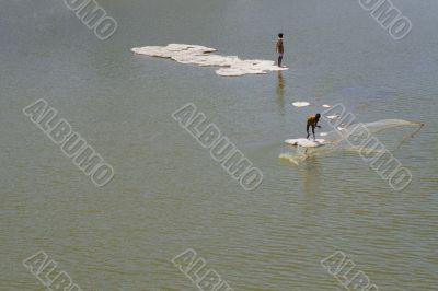 Fishermen on a lake.