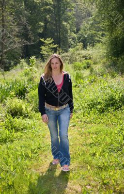 Pretty brunette walking through the field