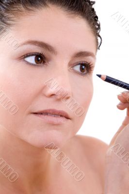 Applying eyeliner
