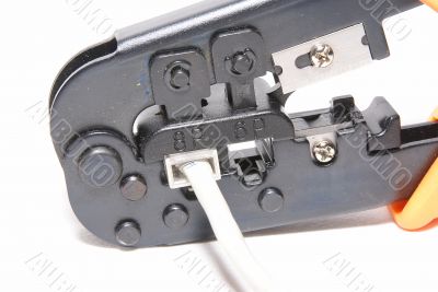 RJ-45, RJ-11 crimping tool with cable.  Macro.