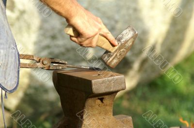 black smith make with forge hammer an arrow