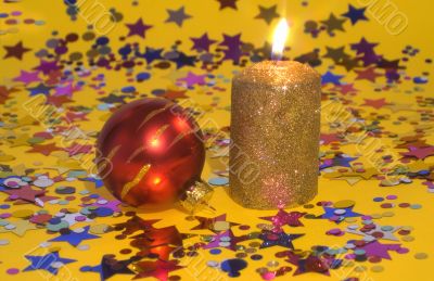 Gold candle and red glass ball