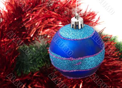Christmas blue ornaments and red tinsel