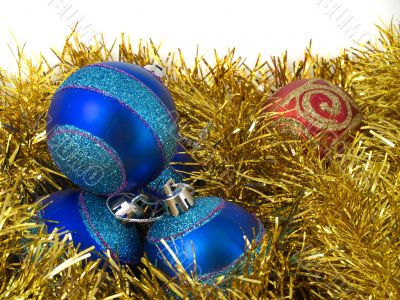 Christmas blue ornaments and gold tinsel