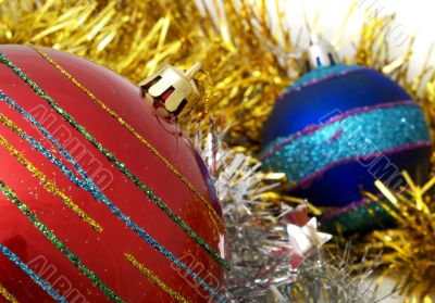 Christmas red and blue ornaments and gold tinsel