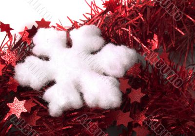 Christmas snowflake on red tinsel backrownd