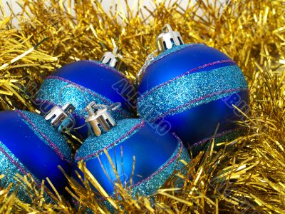 Christmas blue ornaments and gold tinsel