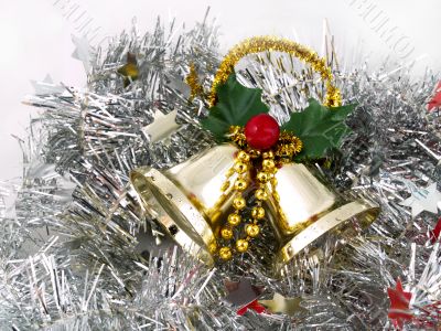 Christmas bells on silver tinsel background