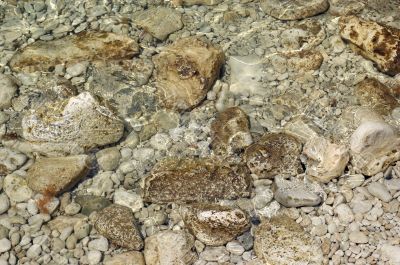 pebbles under rippled water
