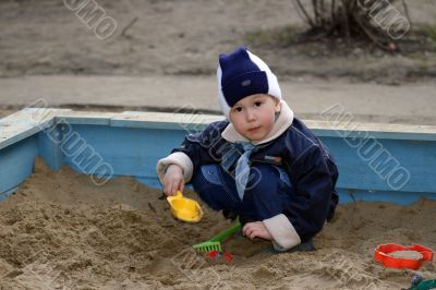 The child, playing to a sandbox